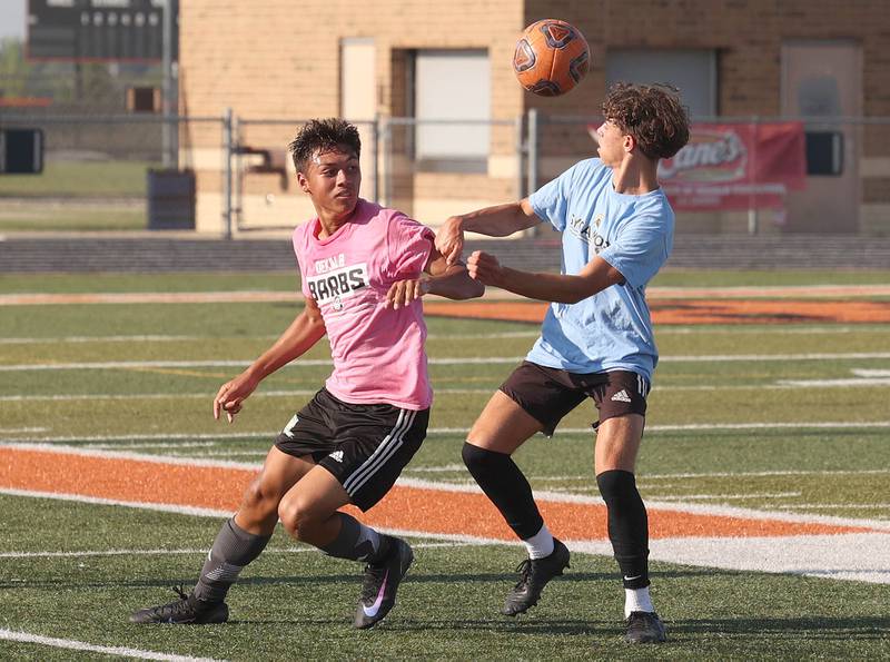 Sycamore’s Noah Daykin (right) and a DeKalb player try to win possession Monday, July 14, 2025, during a summer boys soccer friendly at DeKalb High School.