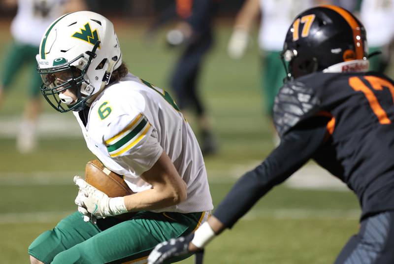 Waubonsie Valley's Sean Bizon makes a catch in front of DeKalb's Jayden Wilson during their game Thursday, Oct. 20, 2022, at DeKalb High School.