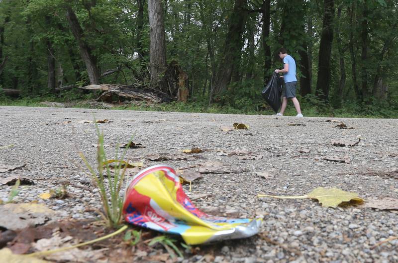 Cooper Lamps helps clean trash next to the Illinois and Michigan Canal during the 815 Day event on Thursday, Aug. 15, 2024 in La Salle. T he City of LaSalle Foundation held the inaugural community-wide Day of Service held the park cleanup at St. Mary's Park and the Illinois and Michigan Canal.   The Foundation welcomes teams from businesses, nonprofits, and others, as well as enthusiastic individuals looking for an opportunity to create change in the community.