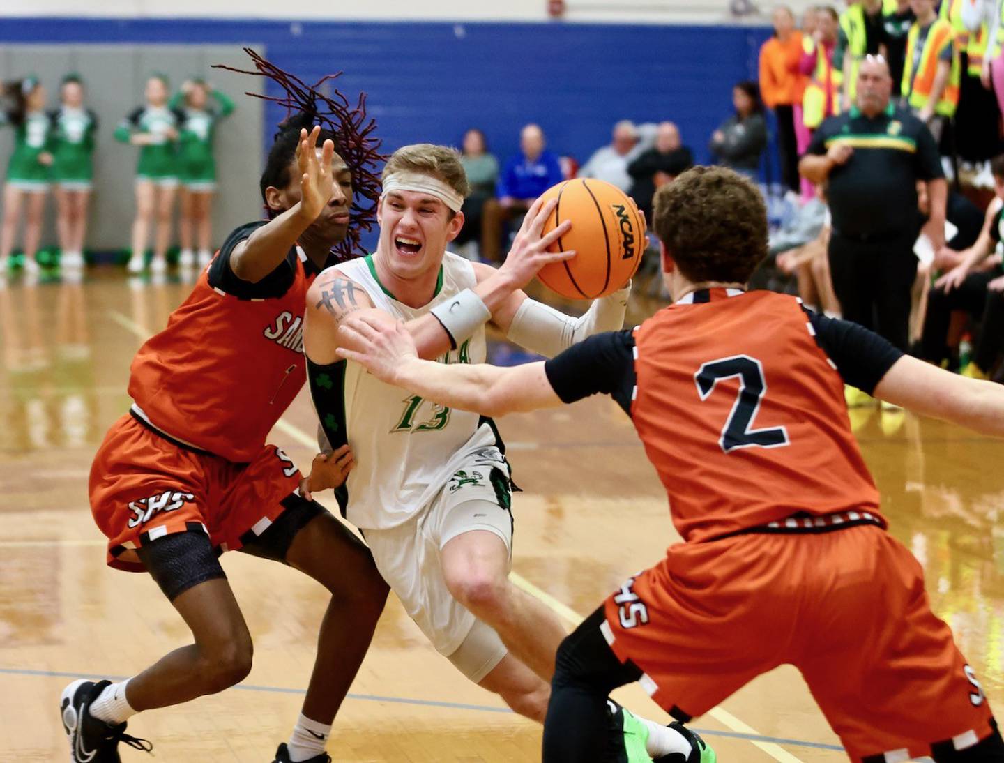 Seneca's Paxton Giertz drives between Sandwich's Simeion Harris (left) and James Zydron (2) in the Class 2A regional semifinal game at Princeton this past season.