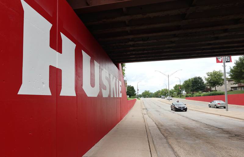 Vehicles drive by part of the new Huskie mural Monday, Aug. 7, 2023, on the Annie Glidden Road railroad underpass, just south of Lincoln Highway in DeKalb. The mural was a joint project between the City of Dekalb and Northern Illinois University.
