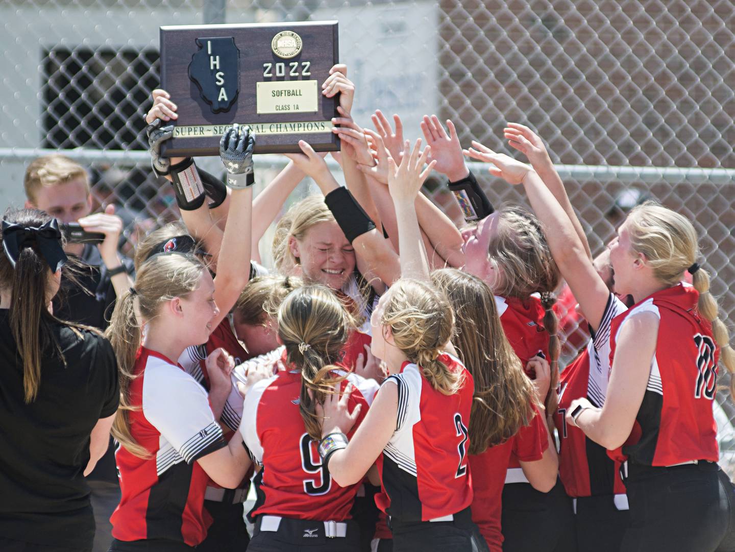 The Forreston softball team hoists their supersectional plaque after beating West Central 6-5 Monday, May 30, 2022.