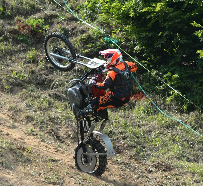 Wade Schultz of Lisbon, Iowa, tries to hang on as his motorcycle goes vertical while making a run at the Rock River Riders Motorcycle Club's hillclimb on Sunday, Aug. 3, 2025.