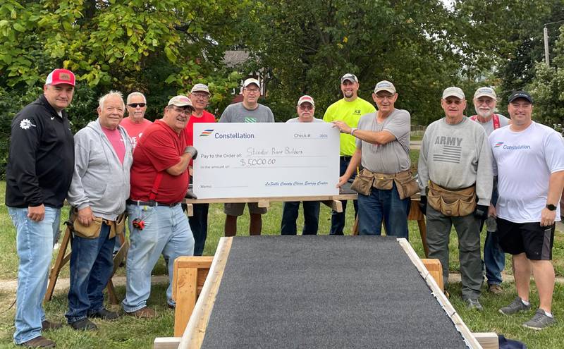 Employees from the La Salle Clean Energy Center joined the non-profit Streator Ramp Builders at one of its wheelchair builds Friday at a home in Marseilles.