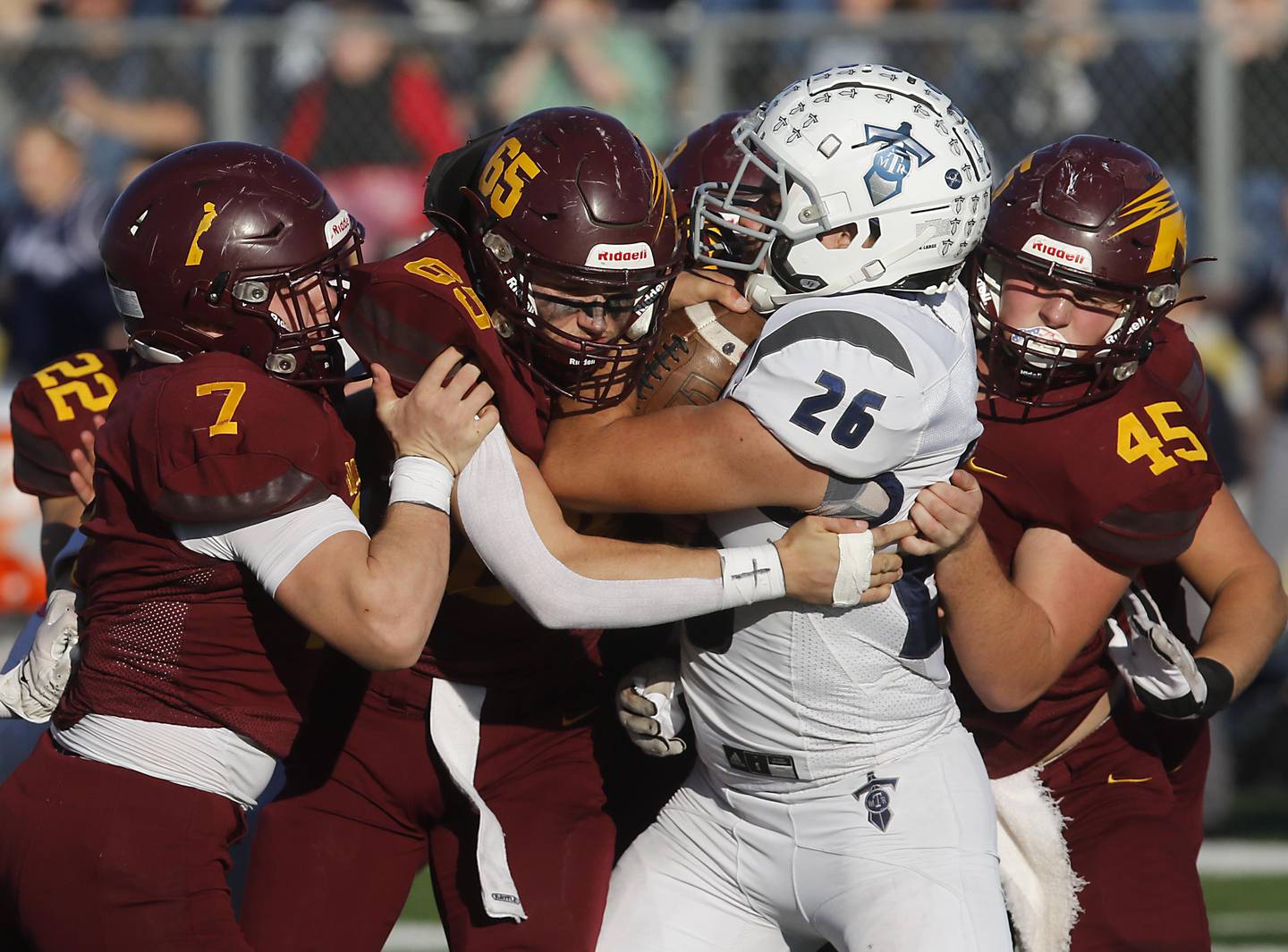 Richmond-Burton's Blake Livdah, Trevor Szumanski, and Riley Shea tackle Monmouth-Roseville's Elijah Noel during an IHSA Class 3A quarterfinal playoff football game on Saturday, November 15, 2025, at Richmond-Burton High School, in Richmond.