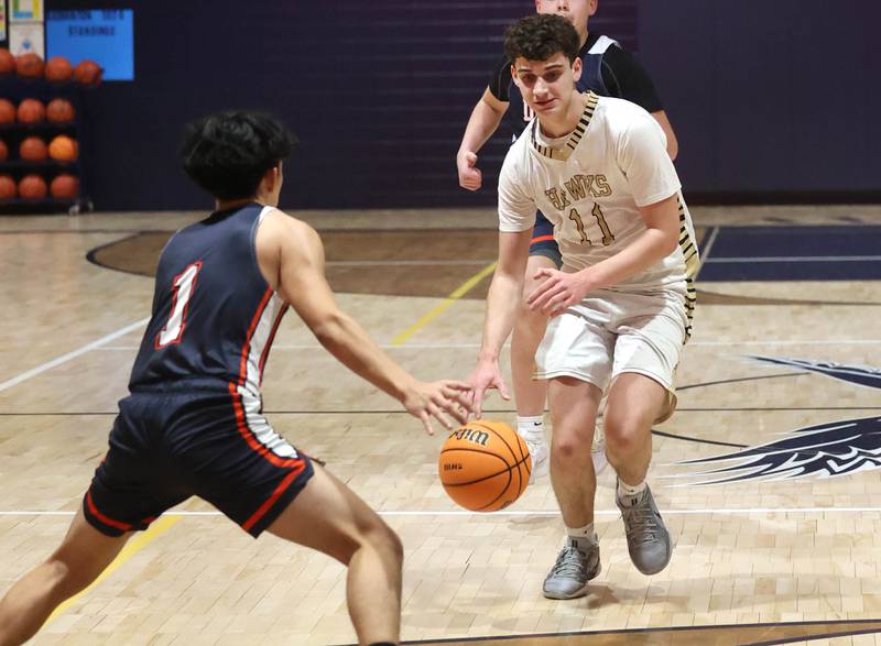 Hiawatha’s Jackson Davenport brings the ball up against DePue’s Pedro Lopez during their game Tuesday, Jan. 20, 2026, at Hiawatha High School in Kirkland.