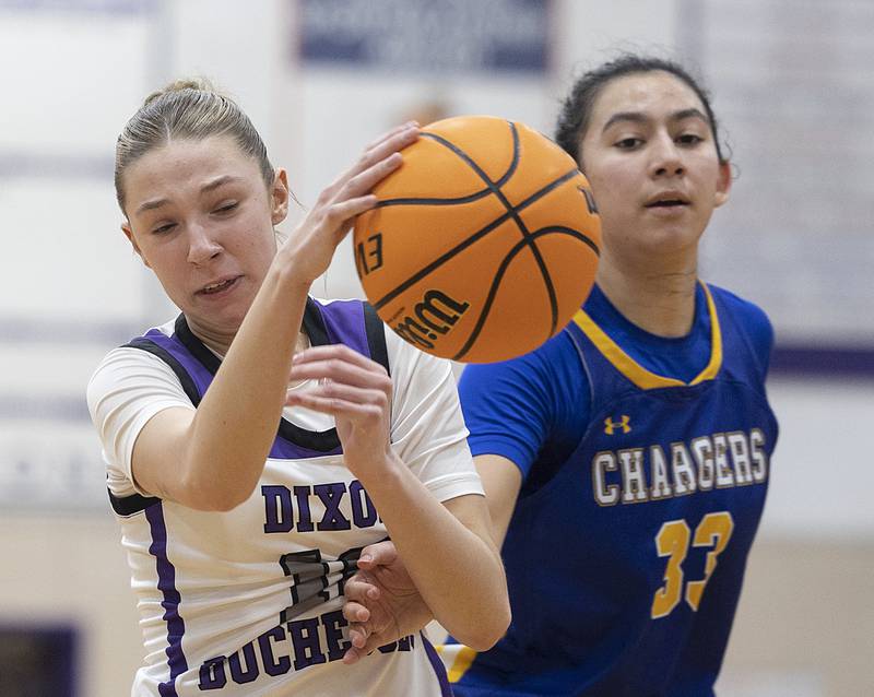 Dixon's Addy Lohse makes a pass against Aurora Central’s Sofia Corral Thursday, Dec. 26, 2024, during the Dixon Girl’s KSB Holiday Basketball Classic.