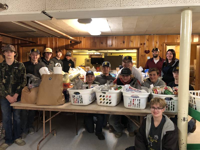 The members who participated in the FFA Fall Food Drive are, left to right, Carson Schlosser, Braden Bickerman, Amos Vincent, A.J. Furar, Jacob Edens, Evan Siegmann, Miles Walder, Julien Linton, Zac Lequia, Easton Fiorentini, Cole Boedigheimer, Anna Mae Smith (sitting). In the back are their FFA advisors, Mr. McManus and Ms. Harris.