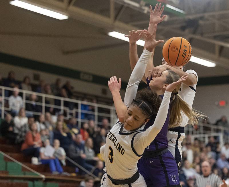 Sterling’s Delali Amankwa, Dixon's Morgan Hargrove and Sterling’s Joslynn James get tangled up Thursday, Feb. 27, 2025, during the Class 3A girls Sectional title at Rockford Boylan High School.