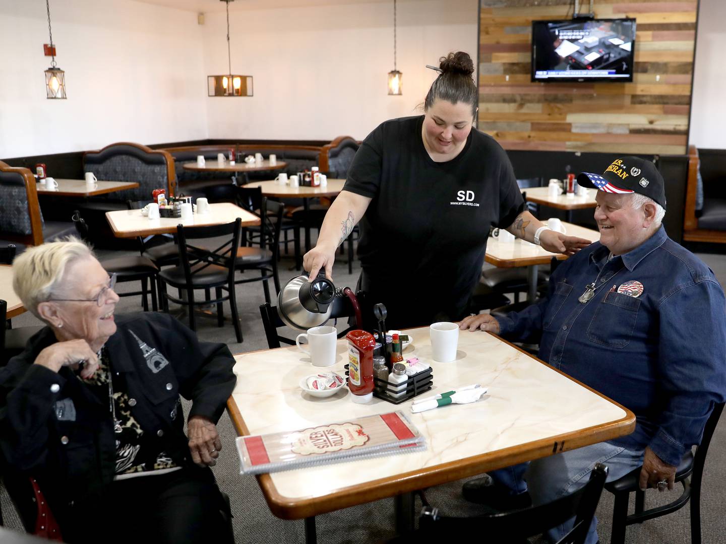 Ashley Medows pours coffee for Lori Michelson and Roger Treend of Bristol at Yolkville, the former Silver Dollars Restaurant at 102. E. Stagecoach Trail in Yorkville