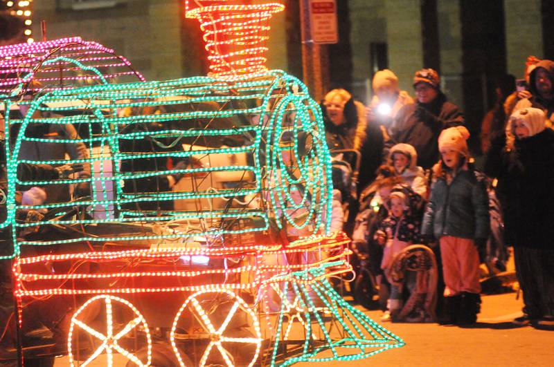 A lit-up train passes by spectators during the Festival of Lights parade in downtown Ottawa on Friday, Nov. 26, 2021.