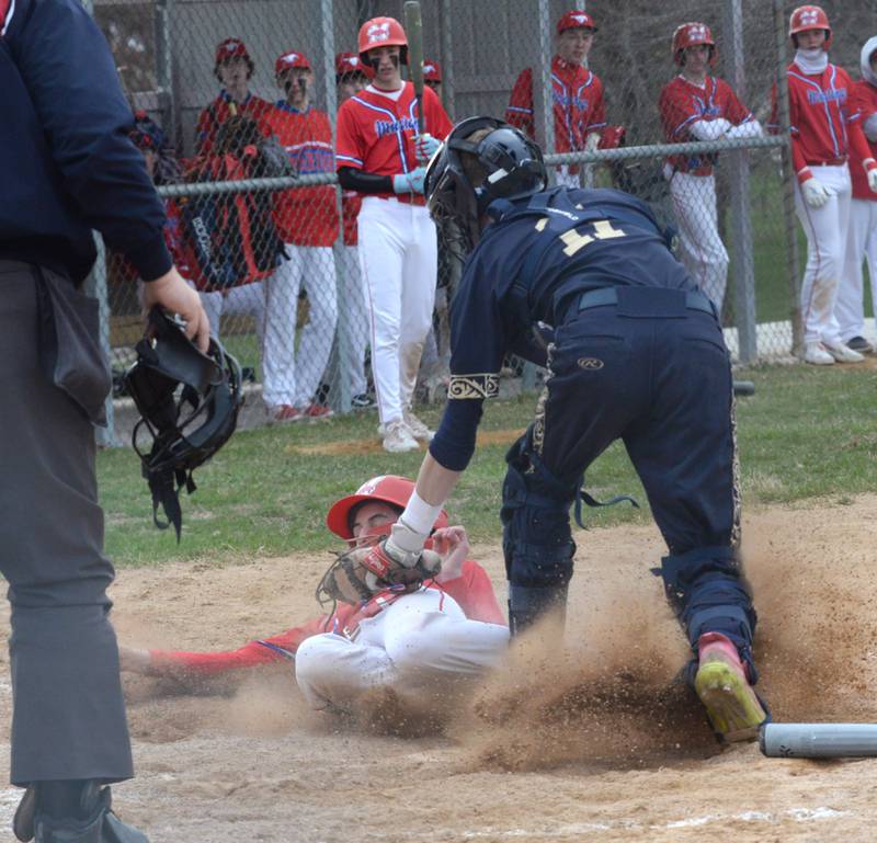 Polo catcher Jackson Willis tags out Morrison's Jacob Banks at home plate during a Thursday, April 10, 2025 game in Polo.