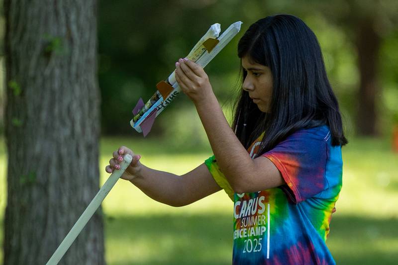 Alexa loads paper rocket onto launcher at the 23rd annual Carus Summer Science Camp on Friday, July 18, 2025 at St. Bede High School in Peru.