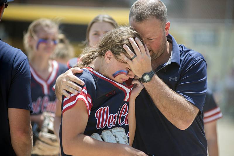 West Central’s Addie Seitz is comforted by the coach after giving up home runs against Forreston Monday, May 30, 2022.