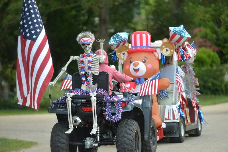 Entries in the 7th Annual Grand Detour Golf Cart Parade cruise past the John Deere Historic as they start their jaunt around the village on Sunday, July 6.