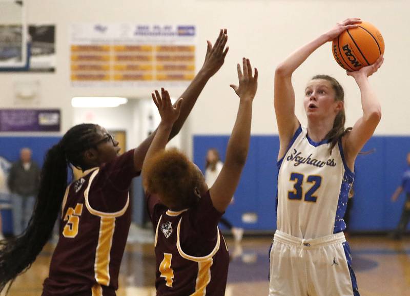 Johnsburg's Skye Toussaint (right) shoots th ball over Chicago Marshall's Chamarre Scott (left) and Lanyla Sago (center) during a IHSA Class 2A Johnsburg Sectional girls basketball semifinal game on Tuesday, February, 24, 2026, at Johnsburg High School.