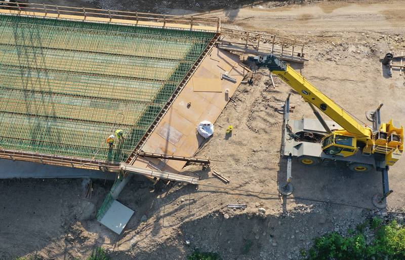 An aerial view of crews working on the Interstate 180 bridge crossing over Tiskilwa Bottom Road on Tuesday, July 8, 2025 near Tiskilwa. The Illinois Department of Transportation continues to work on the 180 bridges over Bureau Creek and Tiskilwa Bottom Road.  The I-180 work zone is a mile south of the Route 26 interchange. Both the south and northbound bridges are being replaced. Girders have been installed on the bridge. Tiskilwa Bottom Road remains closed under I-180 during the project and traffic should follow the posted detour signs. The 24.2 million project is scheduled to be completed by the end of 2026.