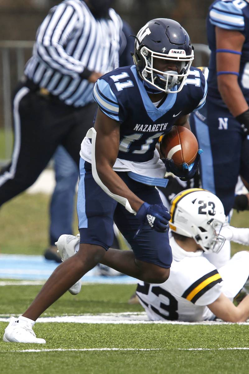 Nazareth’s Quentrell Harris runs for a touchdown during their football game at Nazareth Academy in LaGrange Park, Ill., on Saturday, March 27, 2021.