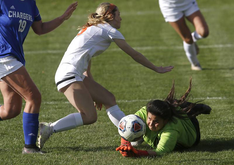 Dundee-Crown's Ashley McAtee dives after the ball in Crystal Lake Central's Carter Thompson tries to score during a Fox Valley Conference soccer match Tuesday April 26, 2022, between Crystal Lake Central and Dundee-Crown at Dundee-Crown High School.