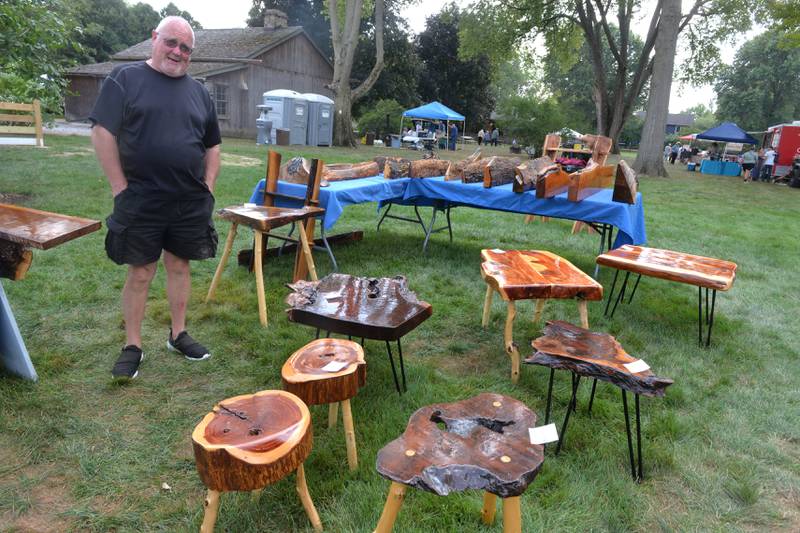 Peter Bell of Oregon stands next to some of his rustic wood creations at the 74th Grand Detour Arts Festival held on Sunday, Sept. 10, 2023 at the John Deere Historic Site in Grand Detour.
