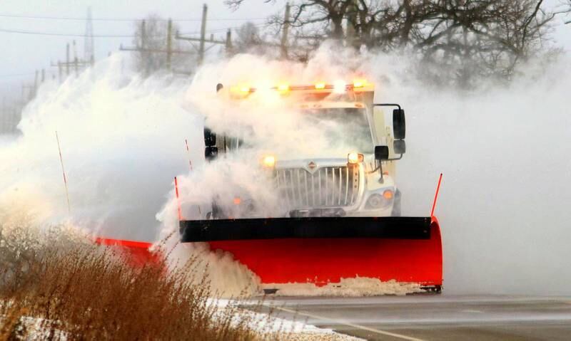 Patrick Kunzer for Shaw Local
A plow carves through drifts and heavy wind as it moves south along Route 23 in Marengo Friday morning.