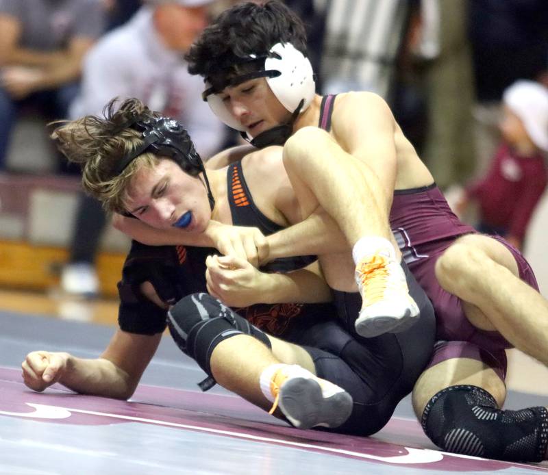 McHenry’s Rafael Perez, left, battles Prairie Ridge’s Eli Ruiz at 144 pounds in varsity boys wrestling on Thursday, Jan. 8, 2026 at Prairie Ridge High School in Crystal Lake.