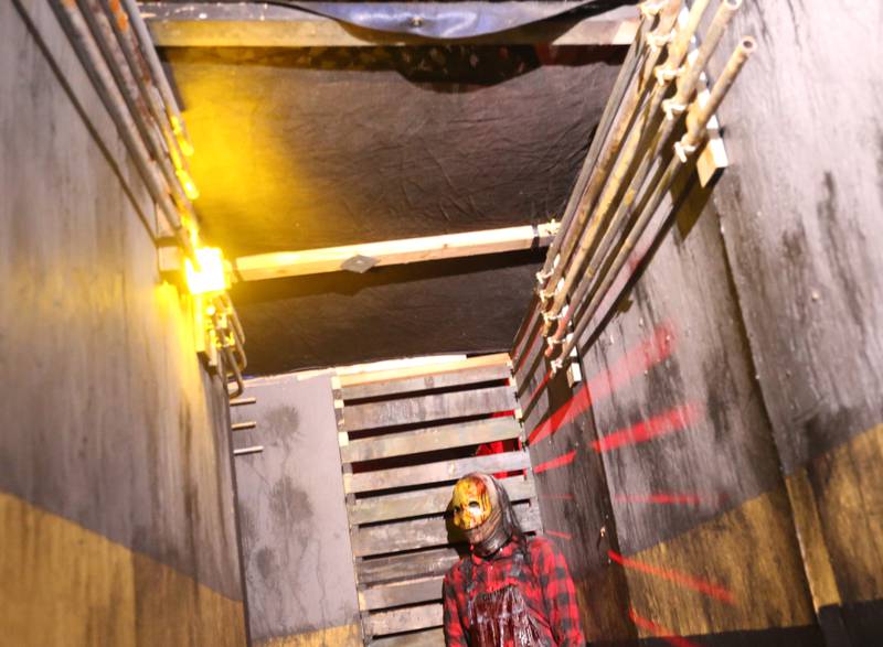 A character stands at the end of a hallway inside the Insanity Haunted House on Thursday, Oct. 12, 2023 at the Peru Mall. Notice the fake piping, painted walls and other details that owner Pete Pavia puts into the attraction each year.