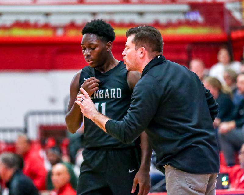 Glenbard West's head coach Jason Opoka coaches up Teyion Oriental (11) during their basketball game between Glenbard West at Hinsdale Central, Friday  Dec 6, 2024  in Hinsdale.