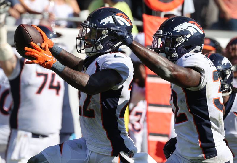 Denver Broncos safety Kareem Jackson celebrates his game clinching interception with teammate Denver Broncos safety Delarrin Turner-Yell during their game Sunday, Oct. 1, 2023, at Soldier Field in Chicago.