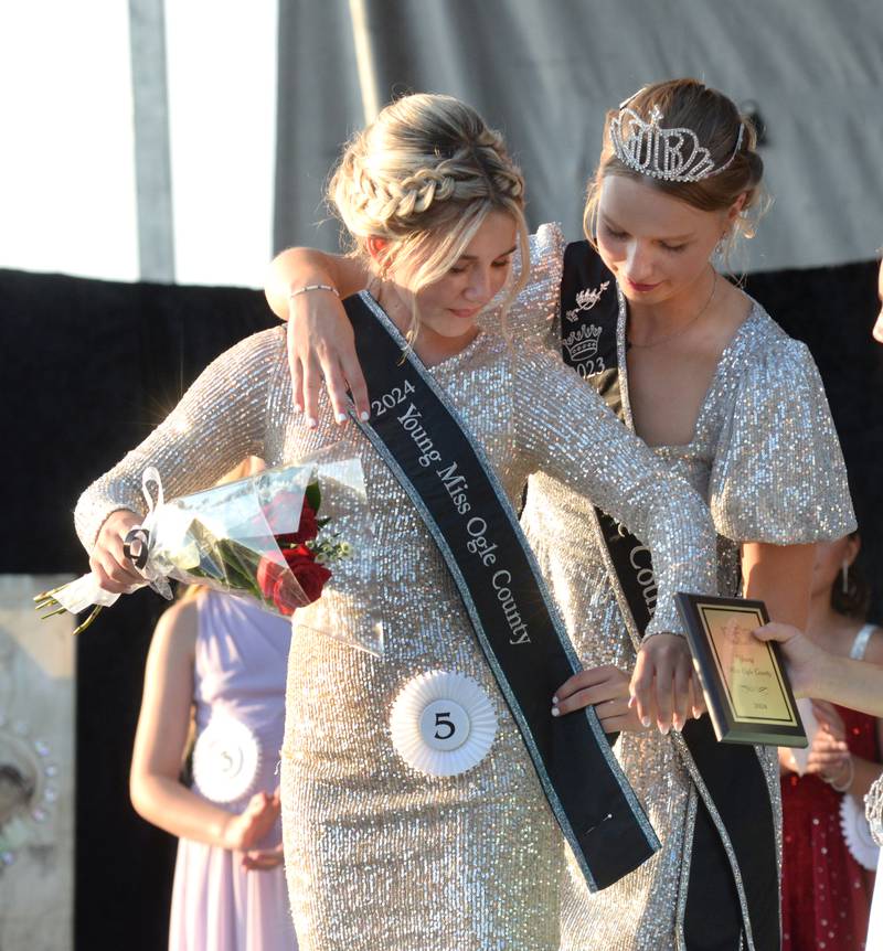 2024 Young Miss Ogle County, Emma Wissinger, 12, receives her crown and sash from  2023 Ogle County Fair Queen Lauren Carlson at the Ogle County Fair Pageant on Wednesday, July 31, 2024.