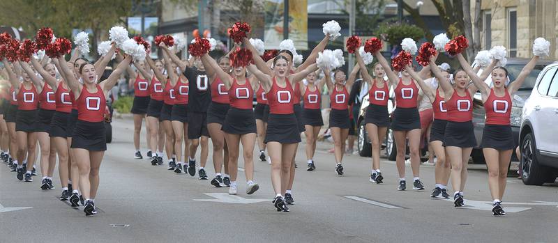 The Ottawa High Poms and Cheerleaders march down LaSalle St in Ottawa Wednesday evening during the school’s annual Homecoming Parade.