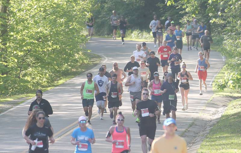 Hundreds of runners pass by the entrance to Starved Rock State Park while competing in the Starved Rock Country half-marathon on Saturday, May 10, 2025 at Starved Rock State Park.