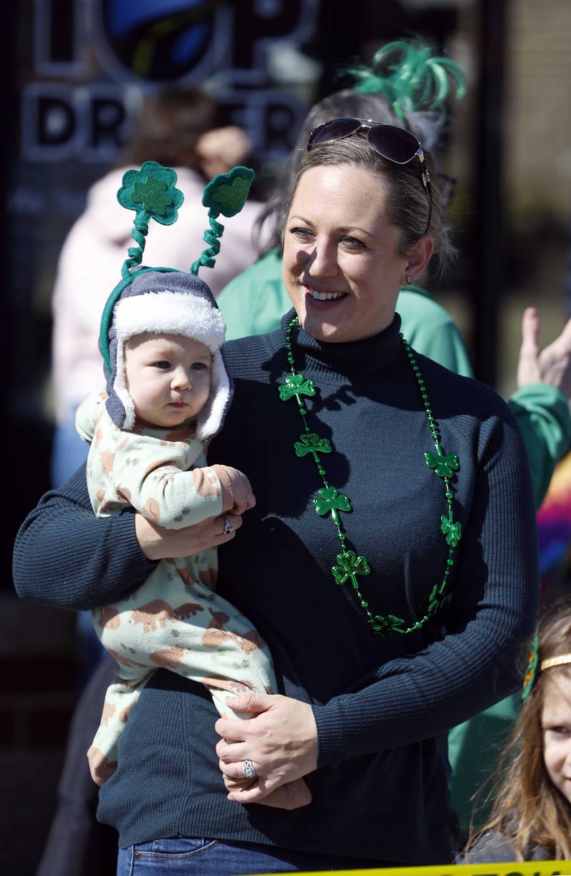 Christiana Dropka of Addison holds her son Lukas 6 months, as the annual St. Patrick’s Day Parade passes them Saturday, March 8, 2025 in Elmhurst Ill.