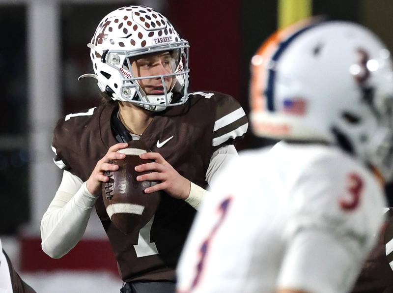 Mount Carmel's Emmett Dowling looks for a receiver Wednesday, Dec. 3, 2025, during their IHSA Class 8A state chamionship game against Oswego in Huskie Stadium at Northern Illinois University in DeKalb.