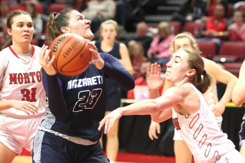 Nazareth's Danielle Scully goes to the basket against a Morton defender during their Class 3A state semifinal game Friday, March 4, 2022, in Redbird Arena at Illinois State University in Normal.