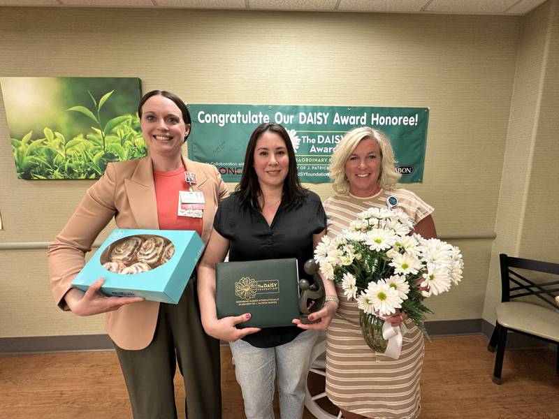 Biatris Escatel, RN at OSF Saint Clare Medical Center, was honored with the 2025 DAISY Award for her compassionate care and dedication to patients. From left: Lori Anderson, DNP, Inpatient Services manager; 2025 DAISY Award Winner, Biatris Escatel, RN; Heather Bomstad, chief nursing officer.