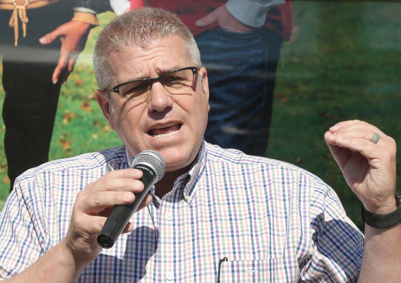 Darren Bailey, a Republican candidate for Illinois governor, speaks in front of his bus Friday, June 17, 2022, during his campaign stop at Tom and Jerry's in Sycamore. Bailey is currently on a bus tour across the state that will cover 102 countys in 14 days.