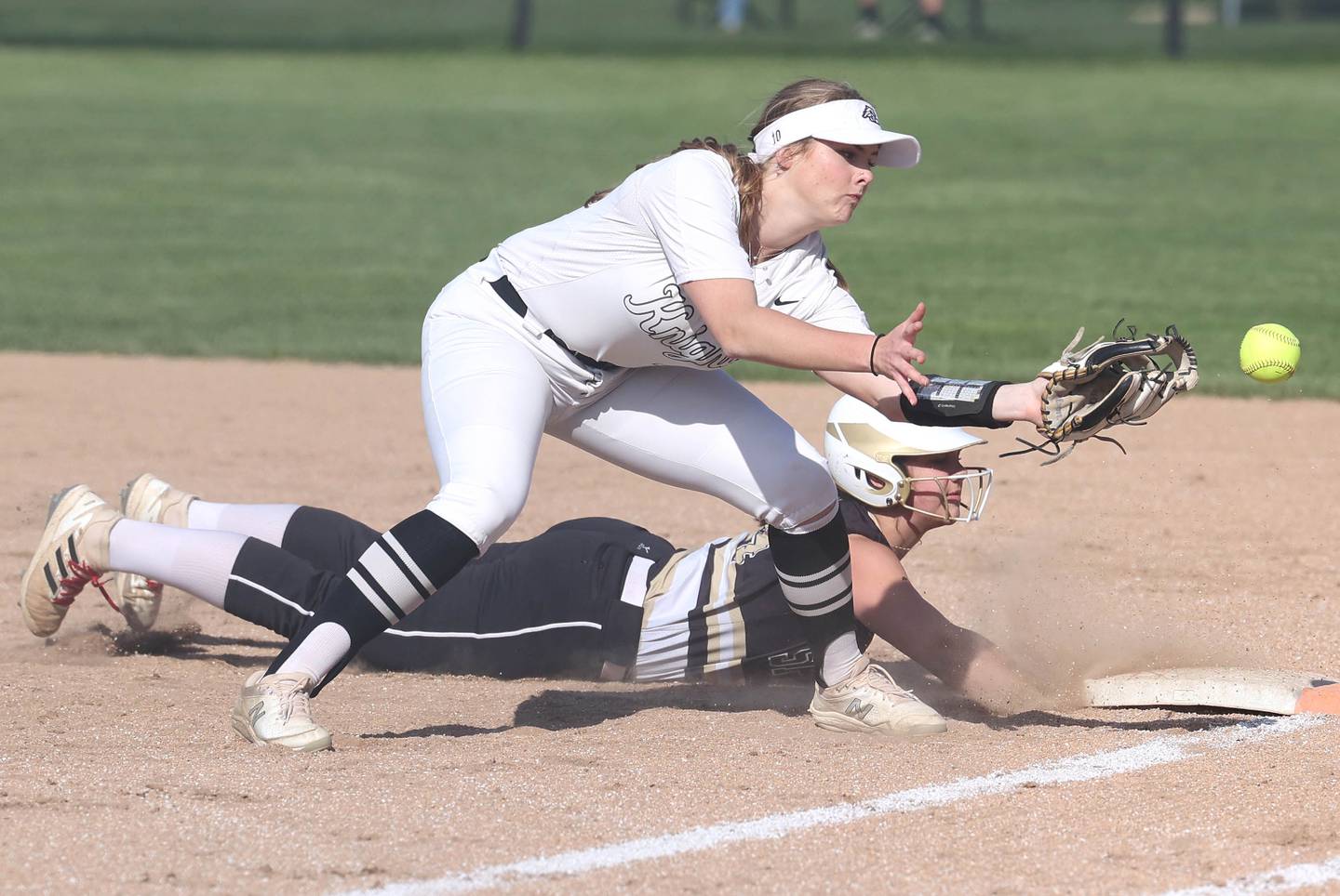 The ball gets by Kaneland's Emily Olp as they try to pick off Sycamore's Kairi Lantz Friday, April 28, 2023, during their game at Sycamore High School. Lantz advanced to second on the play.
