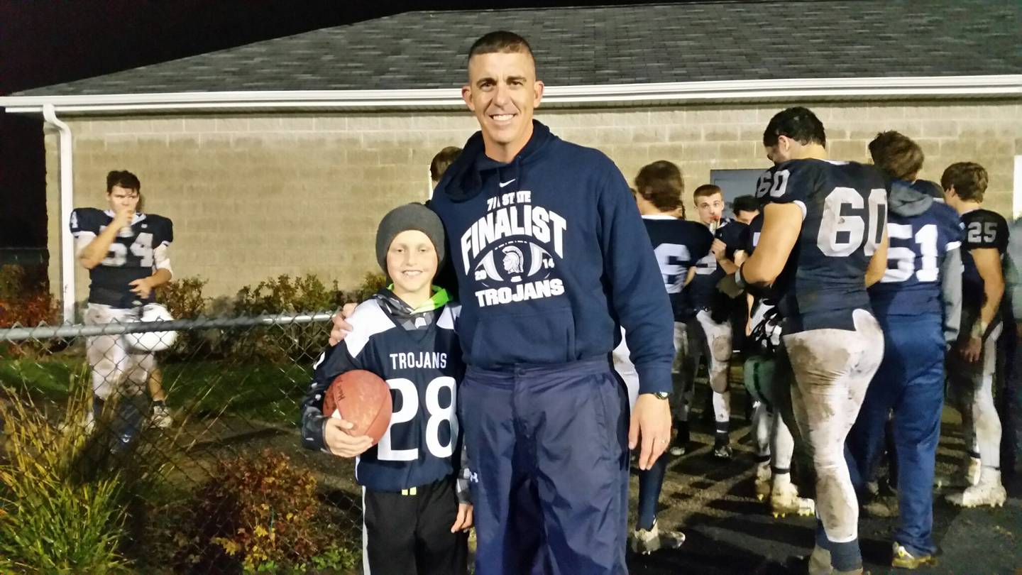 Cary-Grove football coach Brad Seaburg poses for a picture with Brock Iverson in 2015. Iverson, a cancer survivor, is finishing up his senior baseball season for the Trojans.