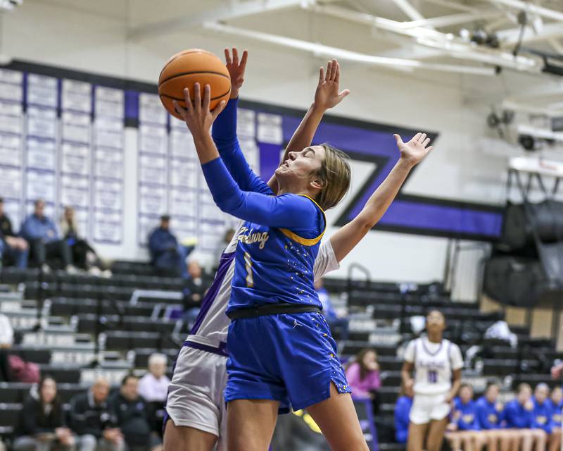 Johnsburg's Ava Jablonski (1) attempts a lay up during their basketball game between Johnsburg at Plano, Monday Dec 16, 2024 in Plano.