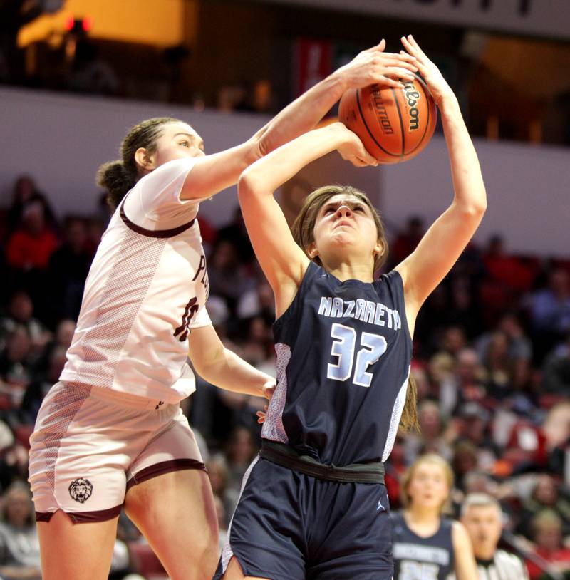 Nazareth Academy's Stella Sakalas (right) has her shot blocked by Peoria's Denali Craig Edwards (left) during the Class 3A girls basketball state semifinal at Redbird Arena in Normal on Friday, March 3, 2023.