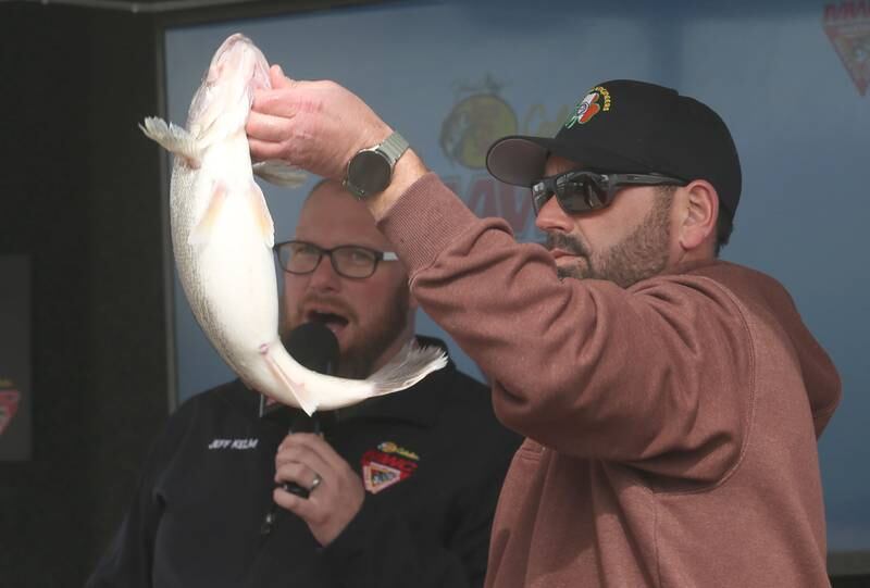 Corey Blair of Utica, holds his big walleye fish during the annual Masters Walleye Circuit tournament on Friday, March 21, 2025 at the Spring Valley Boat Club.