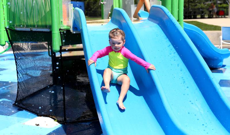 Skylar Greulich, 2, goes down a slide at the Otter Cove Aquatic Park’s Splash Park on Tuesday, June 24, 2025 in St. Charles.