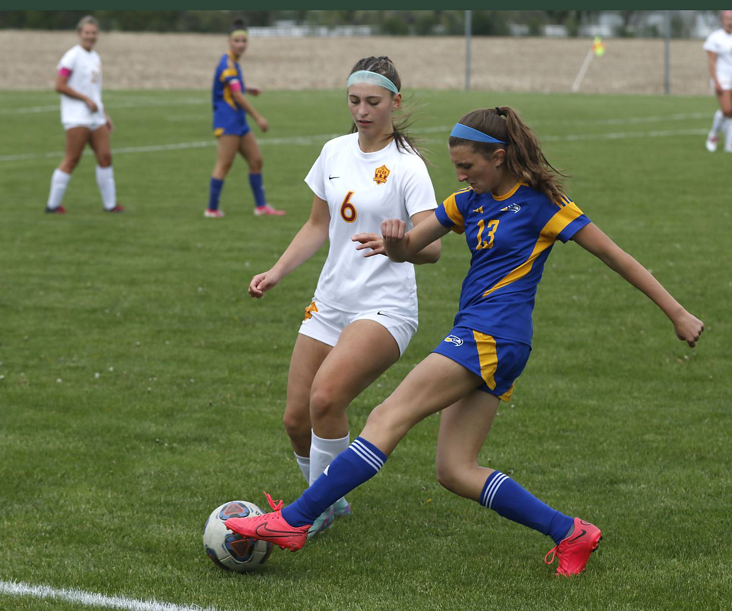 Johnsburg's Dorothy Ruth kicks the ball as Richmond-Burton's Charlotte Gentry defends during the Kishwaukee River Conference Girls Soccer Tournament Championship match on Wednesday, May 6, 2026, at Johnsburg High School.