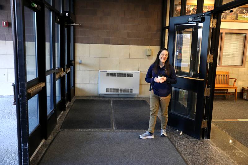 St. Charles Police Officer Jennifer Larsen, the school resource officer at St. Charles East High School, greets students as they arrive at the school one recent morning.