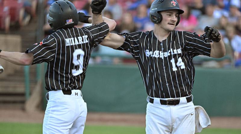 St. Charles East’s Mac Paul, right, celebrates his 2 RBI hit with teammate Devin Minarik in the third game of their inter-city series against St. Charles North at Northwestern Medicine Field in Geneva on Tuesday, April 20, 2024.