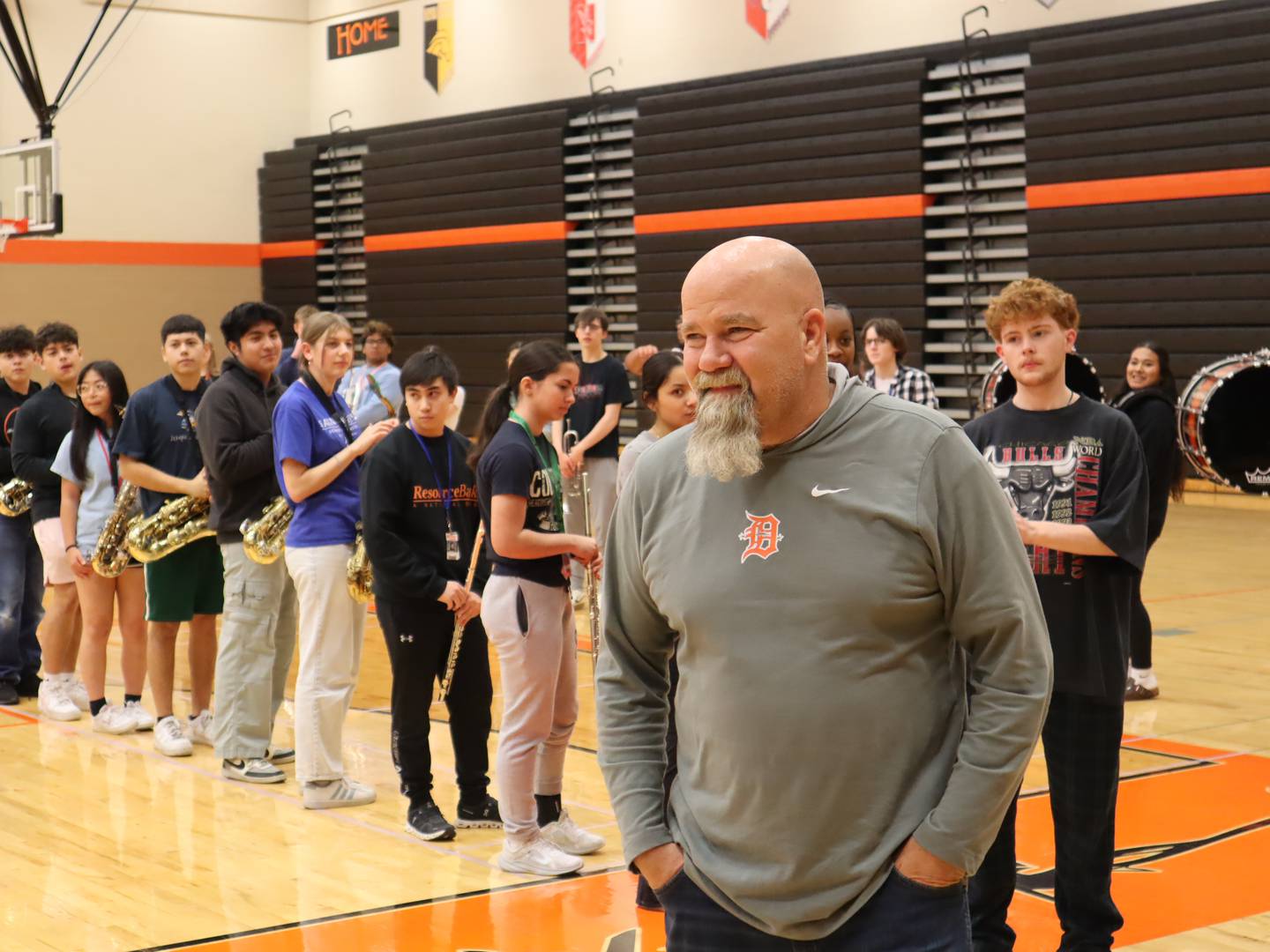 DeKalb School District 428 driver's education instructor and assistant athletic director Mark Sykes reacts to a surprise award ceremony on April 25, 2025, at DeKalb High School, 501 W. Dresser Road. Sykes was named the 2025 Wirtz Award winner for excellence in education.