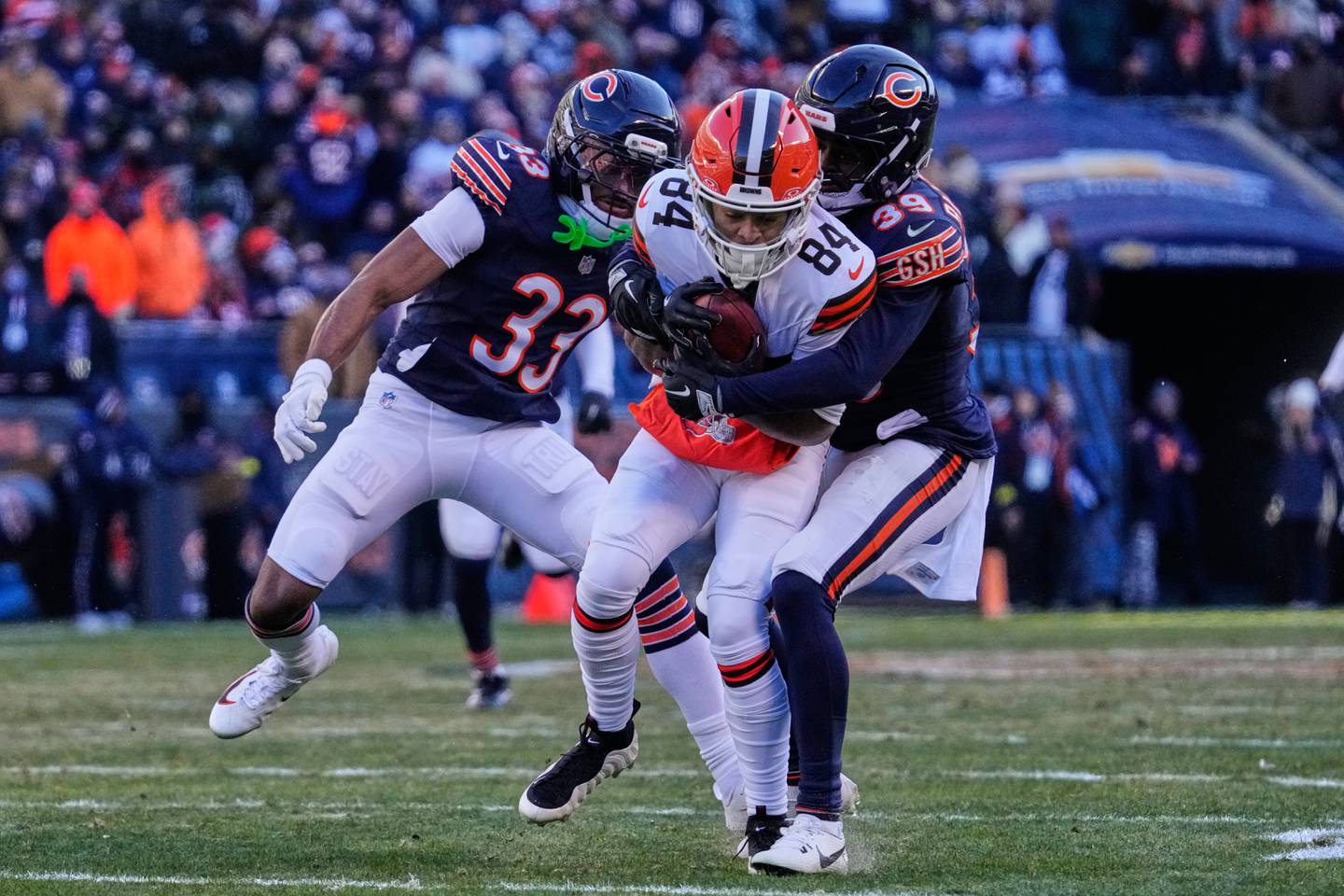 Cleveland Browns wide receiver Gage Larvadain (84) is tackled by Chicago Bears cornerback Josh Blackwell (39) in front of Jaylon Jones (33) in the second half of an NFL football game in Chicago, Sunday, Dec. 14, 2025. (AP Photo/Nam Y. Huh)