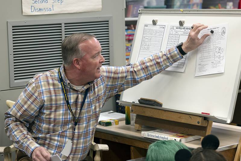 Brian Lobdell, a second grade teacher at Franklin Elementary School in Sterling, sets out reading materials for his students on Thursday, March 27, 2025, to kick off the day's lessons.