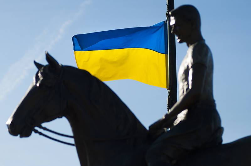 The Reagan statue at Heritage Crossing in Dixon is seen backed by Ukrainian flag Tuesday, March 1, 2022. A pair of the flags were posted at the park in support of the sovereign country after being invaded by Russia. Flags from Dixon's sister cities typically are flown at the spot.